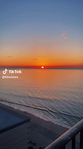 Serene Sunset Over Calm Ocean from Balcony View