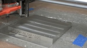 CNC machine router drilling a hole in aluminum