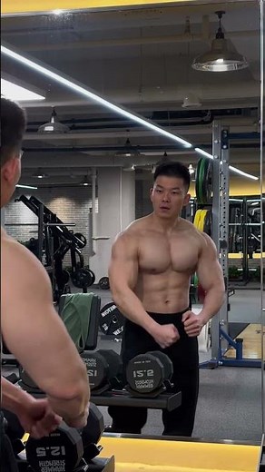 Muscular man, with abs, pecs, and arm muscles.