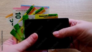 euro banknotes, brown leather wallet with German public health insurance cheaper, electronic insurance card, concept medical support on trip to Europe, guarantee of treatment, payments to medical fund