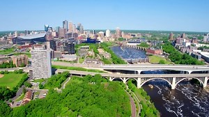 clip-1037303393-minneapolis-skyline-over-river-on-sunny-day