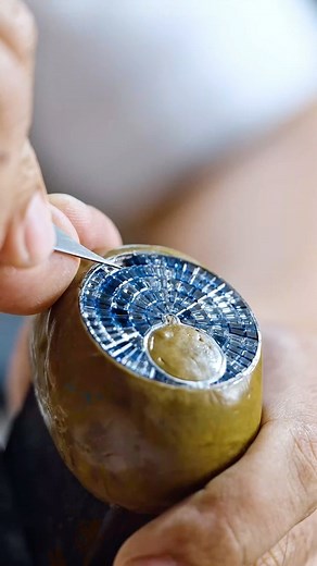 Aleksandar Mladenovic on Instagram: "Crafting the @jacobandco Caviar Tourbillon Blue Camo 🧊 Caviar Tourbillon is entirely covered in gems. They’re not round, as brilliant-cut gems can’t entirely fill any space. Jacob & Co. exclusively selected the baguette cut. In order to recreate the smooth surface of caviar, Jacob & Co. only works with the invisible setting technique. No prongs, no metal appears that would break the continuous array of gems. The 47-mm case is covered in 224 baguette-cut gems