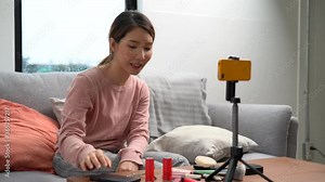 Cheerful Asian female blogger is reviewing cosmetic products and teaching them how to make up, Beauty blogger, Live streaming.