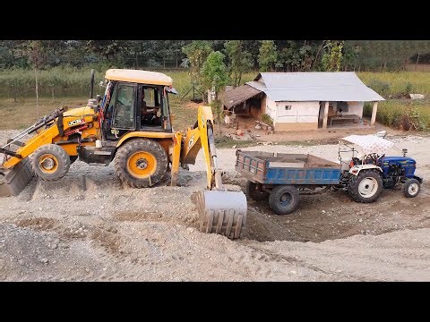 JCB Loading Mud Into Tractor on Construction Site