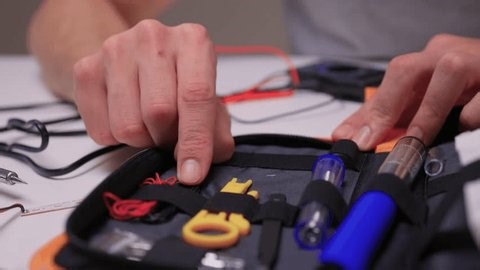 clip-3991460245-skilled-maker-arranging-components-inside-compact-carrying