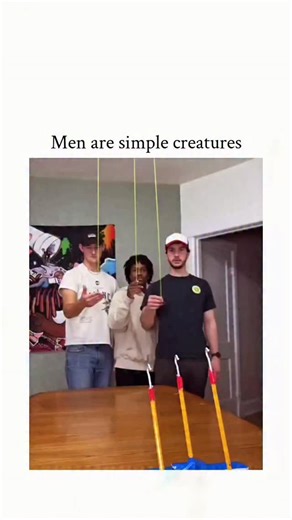 Universal Laughs on Instagram: "The post features a short video of three young men competing in a simple hooking game using ceiling-suspended poles and a table-top box, where the participant with the fewest misses wins a small prize, followed by collective celebration, underscoring the caption's theme of uncomplicated male enjoyment. With over 34,000 likes and 2 million views within hours, replies predominantly affirm the portrayal of men as straightforward and supportive in competition, with us