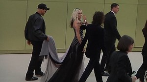 Miley Cyrus in a violet and black gown at the Versace FW23 Show