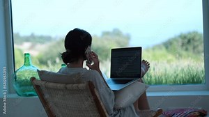 Woman Multitasks with Laptop and Phone Call. Remote Work and Home Office