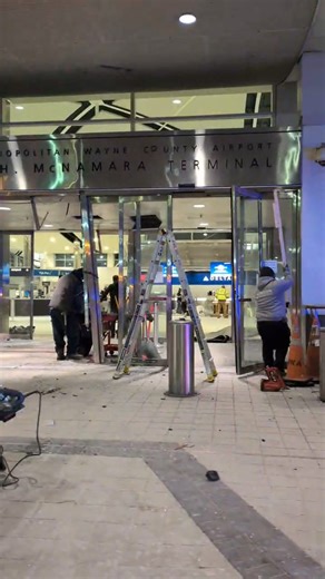 Crews work to repair an entrance to Detroit Metro Airport's McNamara Terminal after a car drove into the terminal on Friday, Jan. 23, 2026. | Detroit Free Press