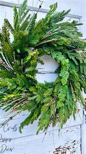 EASY yet elegantly breathtaking: This evergreen wreath is perfect if you’re decorating double doors—multiples can be made to match for a balanced and welcoming entryway. Its classic design makes it easy to transition from Christmas into a cozy winter look. | TCT Crafts - Melissa