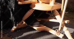 Craftswoman pushing a treadle with her foot, rotating a spinning wheel in slow motion, showcases traditional textile skills. Selective focus Stock Video