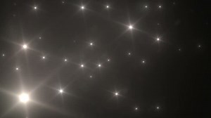 clip-5604782-many-light-flashes-effect-over-black-background