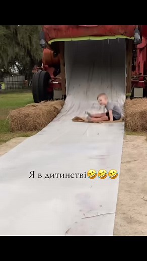 Child Sliding on a White Slide at Outdoor Location