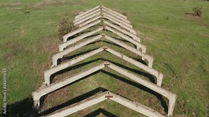 Old abandoned concrete structure farm. Interior of the old ruined abandoned barn for cows. Destroyed agriculture. Old abandoned barn.