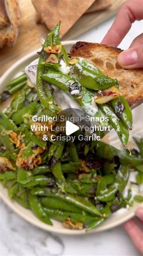 Deliciously Ella on Instagram: "Crispy chilli garlic, zesty yoghurt, grilled sugar snaps. 7 ingredients. 20 minutes. Looking for something flavoursome, zesty and easy to make? Try these! Perfect for sharing with friends at the weekend or as a simple summer supper after work. - 4 large cloves garlic, thinly sliced - Pinch of dried red chilli flakes - 2 packs sugar snap peas (about 400g) - Bunch of fresh mint (about 30g), roughly chopped - 1 tub coconut yoghurt (about 250g) - 1 lemon, zested & jui