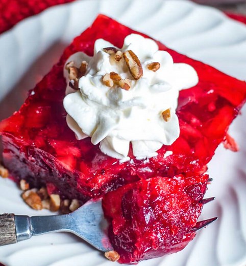 22K views · 48 reactions | Easy, festive Cranberry Jello Salad with pineapple and raspberry gelatin. Three fruit flavors combine to make a gorgeous red fruit dessert that you can serve with a dollop of whipped cream. https://www.tastesoflizzyt.com/cranberry-jello-salad/ | Tastes of Lizzy T | Facebook