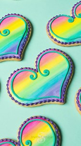 Learn to paint on royal icing with my watercolor rainbow cookie tutorial! https://www.sweetambs.com/tutorial/rainbow-watercolor-cookies/ | SweetAmbs