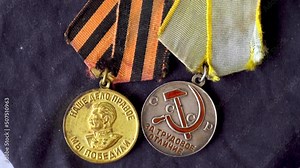 USSR medals. Soviet medals. Victory in WWII. The victory of the Russian people. Image of Stalin. Hammer and sickle. Reward for victory. Labor reward. Gold. Silver. Close-up. Object rotation. The symbo Stock Video