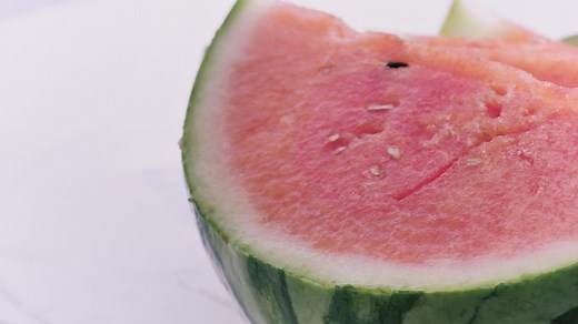 Rich watermelon cut into slices on a white background - Free Stock Video
