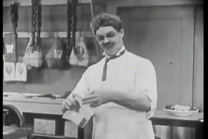 CIRCA 1920s A man working in a deli receives a letter that he is heir to the throne, and shots of his wife and kids crying, and being spanked.