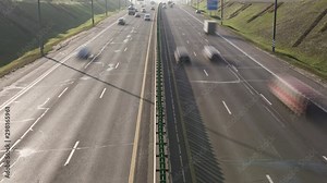 A time lapse footage of traffic on Highway. Highway traffic. Trucks and cars on the road.