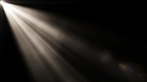 Download Light Beam Shines Through the Darkness in a Searchlight Effect at Night Time for free