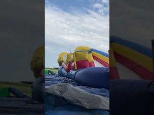 Bouncing on deflating inflatable bounce house slide