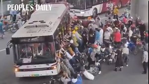 44K views · 780 reactions | Thumbs up! A crowd of passers-by pushed a bus off the ground after a scooter driver was hit by the bus and caught under it in S China's Guangdong. | People's Daily, China | Facebook