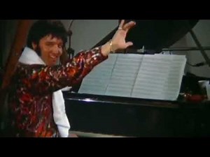 Elvis, playing piano during a studio break...