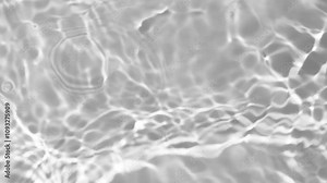 Video captures the rippling patterns of light reflected on the surface of clear water, creating a mesmerizing texture..