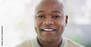 Portrait of the face of one mature African American man with a bright smile and white teeth. A smiling, happy bald black guy showing porcelain veneers after a dental treatment at the dentist