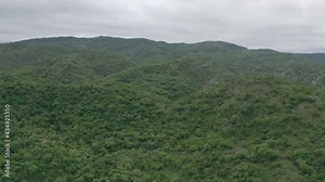 Aerial view of the Omo Valley in Ethiopia. Landscape of savannah overgrown with trees and surrounded by mountains, peaks and ridges. Drone video of Africa and the place from which humanity was born.