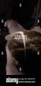 Woman wrapped in spider web on dark background. mental health concept. vertical video