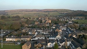Slow Motion clip of the Cumbrian medieval village of Cartmel showing the historic Cartmel Priory at sunset on a winters day.