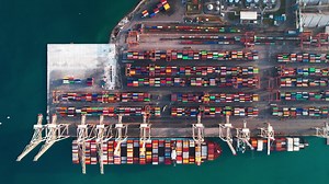 Premium stock video - Aerial view of the shipping port in koper capodistria slovenia loaded with cranes and colorful cargo containers