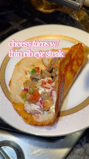 Thinly sliced ribeye steak tacos on crispy, melted cheese #sac #EasyRecipes #SteakTacos #ribeyetacos