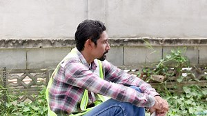 Depressed labor worker sitting on construction site worried about compensation or unemployment during economic financial crisis or low income high expenses, unability recover basic living stability