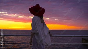 Pretty bohemian woman in hat posing at the sea sunrise, woman in white dress at the pier Stock Video