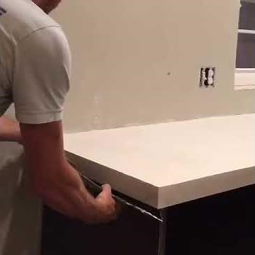 Snapping the Z Counterform off our DIY White Concrete Countertops.