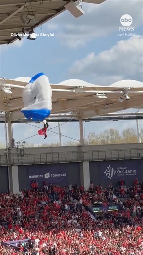 470K views · 1.4K reactions | A pregame show at a rugby match in France went awry when strong winds diverted a parachutist's trajectory, sending them into a roof where they got stuck before eventually being helped down. https://abcnews.visitlink.me/A06lhA | ABC News | Facebook