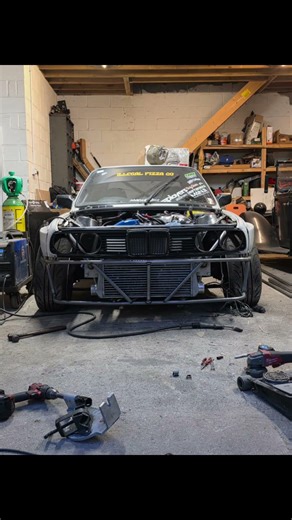 E30 drift car tubed front end, intercooler piping and bash bar.