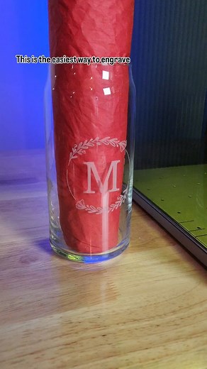 Laser engrave glass with a diode laser. To do this you need a medium on top of the glass so the laser doesn't shine through the clear material. A blue diode laser cannot engrave bare glass. Black tempera paint works great. Add a thin, even coat and let it dry. You'll want to run a test grid first to get your settings right then move on to engraving designs. The xTool F1 Ultra uses a 20W diode and my settings are power 45 speed 50 and 100 lines per cm. Note that little spot on the M that didn't e