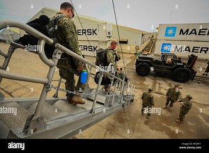 U.S. Navy Explosive Ordinance and Disposal Technicians (EOD), EOD Mobile Unit 3, debark the Sealift Command Joint High-Speed Vessel USNS Spearhead (JHSV 1) upon arriving at Big Creek Port, Belize, May 21, 2014. Sailors and Marines will be participating in Southern Partnership Station 2014, a combined joint exercise focused on subject matter expert exchanges with partner nations and security forces as well as military to military engagements and community relations projects in Central America. (U