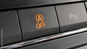 pushing the button to disable the start-stop system of the car close-up