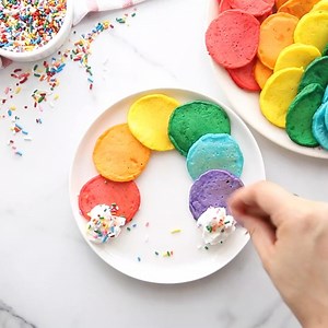 These rainbow pancakes are a fun breakfast! A simple pancake batter and bright colors turns boring pancakes into a fun morning breakfast for the kids. Make them into pancake pops or the shape of a rainbow! Get the full recipe here>> https://www.madetobeamomma.com/rainbow-pancake-pops/ | Made to be a Momma | Facebook
