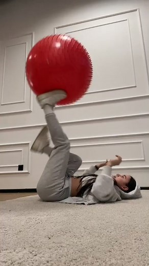 Playful Exercises with a Large Red Exercise Ball