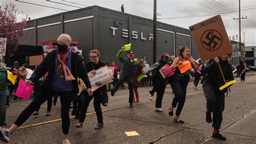 Hundreds protest outside Seattle-area Tesla dealerships as part of worldwide movement