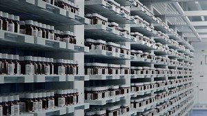 Brown Glass Vials on Shelfs inside Storage Area at Modern Pharmaceutical Factory. Medication Production Plant. Medicine Manufacturing Process.