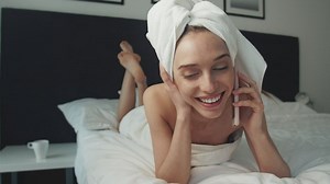 Woman talking on the phone after taking a shower - Free Stock Video