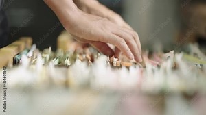 Close-up hand of businesswoman searching for financial and accounting file paperwork in an office file cabinet